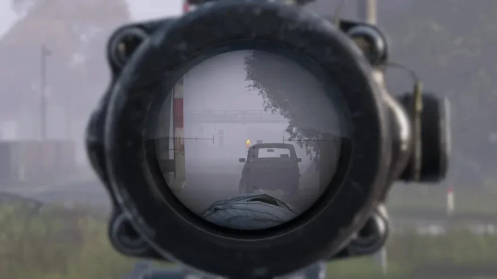 Scope view of a foggy road with a vehicle marker highlighted through the reticle.